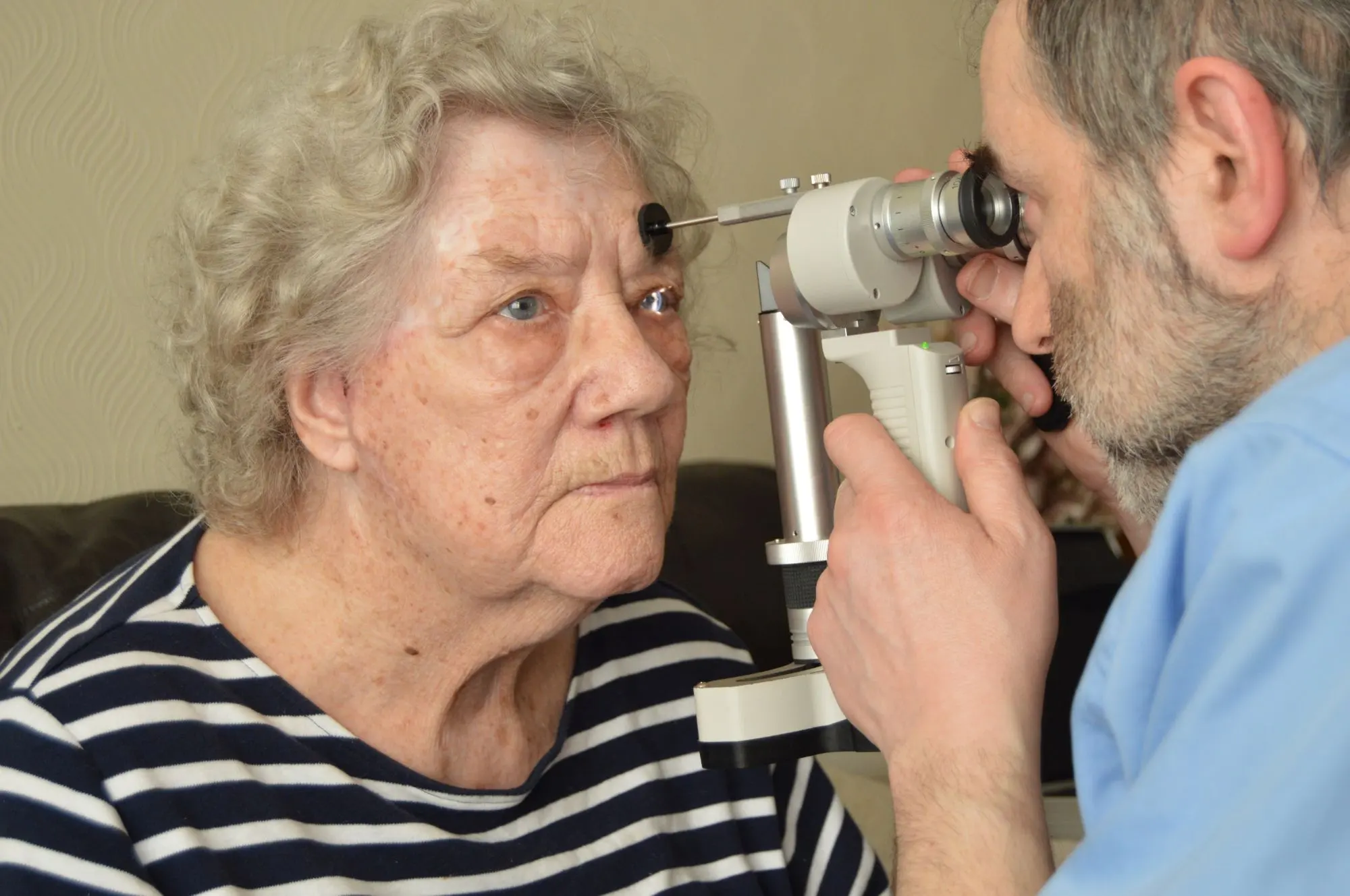Optician checking patients eyes